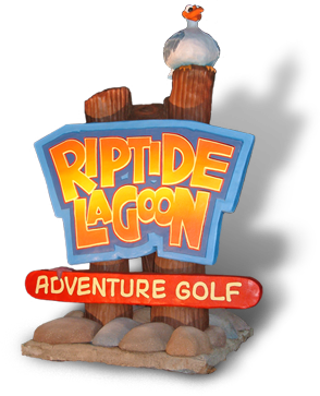 Riptide Lagoon Adventure Golf logo with graphic of logo on sign mounted on wooden logs buried in ground with rocks at the bottom and a cartoon seagull sitting on top of one of the logs